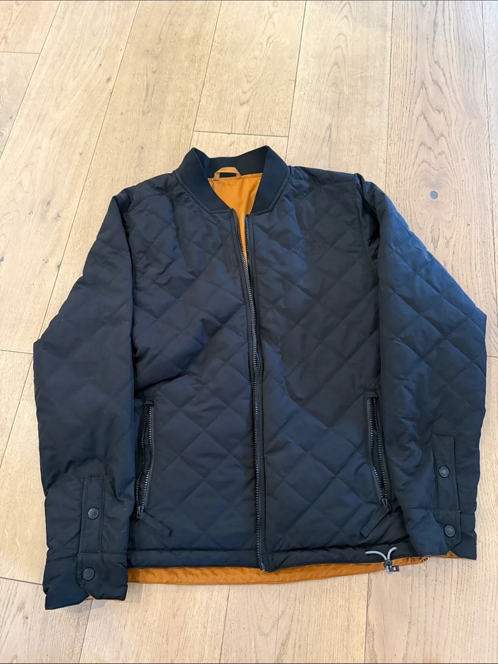 The North Face Men's Quilted Bomber Jacket in Black with Mustard reversible